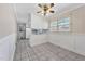 The cozy kitchen includes white cabinets, tiled floors, and natural light from the adjacent dining area at 6709 Johnsdale Rd, Raleigh, NC 27615