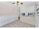 The cozy kitchen includes white cabinets, tiled floors, and natural light from the adjacent dining area at 6709 Johnsdale Rd, Raleigh, NC 27615