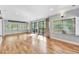 The living room is spacious and bright with hardwood floors, large windows, and patio access at 6709 Johnsdale Rd, Raleigh, NC 27615