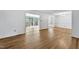 Bright living room with hardwood floors, white walls, and access to an enclosed patio at 6709 Johnsdale Rd, Raleigh, NC 27615