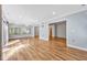 Bright living room features hardwood floors and a view to additional rooms at 6709 Johnsdale Rd, Raleigh, NC 27615