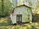 Exterior view of the outbuilding on the property, featuring red framed glass doors at 6709 Johnsdale Rd, Raleigh, NC 27615