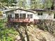 A cozy rear exterior features a wood deck overlooking the backyard area and mature trees at 6709 Johnsdale Rd, Raleigh, NC 27615