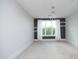 Bright bedroom with large window and neutral carpet flooring at 700 Finsbury St # 306, Durham, NC 27703