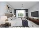 Staged bedroom featuring soft decor, comfortable furniture, and bright window at 700 Finsbury St # 306, Durham, NC 27703