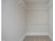 Interior view of walk-in closet with white shelving at 700 Finsbury St # 306, Durham, NC 27703