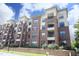 Exterior view of a brick apartment building with balconies at 700 Finsbury St # 306, Durham, NC 27703