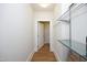 Hallway with wood floors, glass shelving, and a walk-in closet at 700 Finsbury St # 306, Durham, NC 27703
