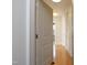 Hallway with hardwood floors and neutral wall colors leading into living space at 700 Finsbury St # 306, Durham, NC 27703