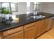 Kitchen island featuring granite countertops and a stainless steel sink at 700 Finsbury St # 306, Durham, NC 27703