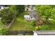 Aerial shot of a spacious backyard featuring a pergola, garden, and a well-maintained lawn at 703 E Horne St, Clayton, NC 27520