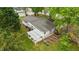 Aerial view of a home showcasing a pergola, garden beds, patio, and a lush green lawn at 703 E Horne St, Clayton, NC 27520