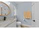 Updated bathroom with a granite vanity and subway tile shower, creating a fresh space at 703 E Horne St, Clayton, NC 27520