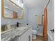 A stylish bathroom features a granite countertop, white subway tile, modern fixtures and bathtub with a shower at 703 E Horne St, Clayton, NC 27520