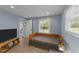 Bright bedroom with neutral paint, wood-look floors, and natural light from window at 703 E Horne St, Clayton, NC 27520