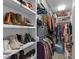 A walk-in closet showcases built-in shelving, with ample storage space for shoes, clothes, and accessories at 703 E Horne St, Clayton, NC 27520