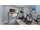 An at-home workout space features a treadmill, a stationary bike and a window view, with ample natural light at 703 E Horne St, Clayton, NC 27520