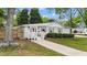 Quaint single-story home showcasing a pink front door, manicured bushes, and a neatly paved walkway to the entrance at 703 E Horne St, Clayton, NC 27520