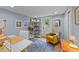 A functional home office showcases a bright chair and a bookshelf with an open doorway to the outside at 703 E Horne St, Clayton, NC 27520