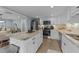 Modern kitchen with white cabinets, granite countertops, and stainless steel appliances at 703 E Horne St, Clayton, NC 27520
