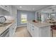 Bright open-concept kitchen with granite countertops, white cabinets, and breakfast bar at 703 E Horne St, Clayton, NC 27520