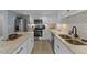 Well-lit kitchen featuring stainless steel appliances, granite counters and white cabinetry at 703 E Horne St, Clayton, NC 27520