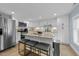 Spacious kitchen featuring granite countertops, stainless steel appliances, and island seating at 703 E Horne St, Clayton, NC 27520