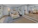 Open-concept living room with light blue walls, neutral furniture, hardwood floors and a glimpse into the dining room at 703 E Horne St, Clayton, NC 27520