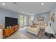 Bright living room featuring light blue walls, neutral furniture, fireplace, hardwood floors and exterior doors to backyard at 703 E Horne St, Clayton, NC 27520
