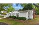 Side view of a well-maintained single-story house with landscaped bushes and a fenced yard at 703 E Horne St, Clayton, NC 27520