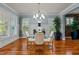 Spacious dining room boasting hardwood floors, large windows with shutters, and contemporary lighting at 714 Mordecai Towne Pl, Raleigh, NC 27604