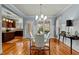 Elegant dining room featuring hardwood floors, modern lighting, and an open view of the kitchen at 714 Mordecai Towne Pl, Raleigh, NC 27604