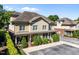 Inviting two-story home features a charming covered porch, complemented by manicured greenery and a convenient parking area at 714 Mordecai Towne Pl, Raleigh, NC 27604
