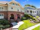 Charming brick townhome with arched entryway, surrounded by lush landscaping and a well-manicured lawn and inviting walkway at 714 Mordecai Towne Pl, Raleigh, NC 27604