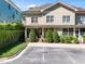 Inviting two-story townhome features a charming covered porch, complemented by manicured greenery and a convenient parking area at 714 Mordecai Towne Pl, Raleigh, NC 27604