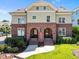 Charming townhomes with matching brick facades and arched entryways, enhanced by lush landscaping and a well-manicured lawn at 714 Mordecai Towne Pl, Raleigh, NC 27604