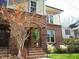 Brick front entrance with beautiful autumn colors, arched doorway, and wrought iron railing at 714 Mordecai Towne Pl, Raleigh, NC 27604