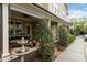 Charming front porch features classic columns, lush greenery, and a decorative fountain, enhancing curb appeal and outdoor enjoyment at 714 Mordecai Towne Pl, Raleigh, NC 27604