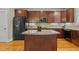 Stylish kitchen with an island, granite countertops, wooden cabinets, and modern appliances at 714 Mordecai Towne Pl, Raleigh, NC 27604