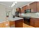 Modern kitchen with a large island, stainless steel appliances, and ample wooden cabinet space at 714 Mordecai Towne Pl, Raleigh, NC 27604
