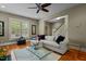 Well-lit living room with hardwood floors, ceiling fan, comfortable seating, and stylish accents at 714 Mordecai Towne Pl, Raleigh, NC 27604