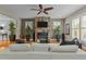 Comfortable living room with hardwood floors, stone fireplace, ceiling fan, and ample natural light at 714 Mordecai Towne Pl, Raleigh, NC 27604