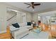 Bright living room featuring hardwood floors, staircase, large sectional sofa and open layout at 714 Mordecai Towne Pl, Raleigh, NC 27604