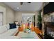 Open-concept living room with hardwood floors, stone fireplace, and seamless flow to the dining area at 714 Mordecai Towne Pl, Raleigh, NC 27604