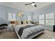 Serene main bedroom featuring a king bed, ceiling fan, and bright windows with shutters at 714 Mordecai Towne Pl, Raleigh, NC 27604