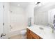 Bright bathroom featuring a shower-tub combo and wood vanity at 746 Wickham Ridge Rd, Apex, NC 27539