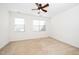 Bright bedroom with neutral carpet, two windows with blinds, and ample natural light at 746 Wickham Ridge Rd, Apex, NC 27539
