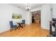 Elegant dining room with a glass table, stylish chairs, hardwood floors, and kitchen view at 746 Wickham Ridge Rd, Apex, NC 27539