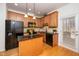 Charming kitchen featuring wood cabinets, granite countertops, and stainless steel appliances at 746 Wickham Ridge Rd, Apex, NC 27539