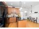Stylish kitchen featuring an island with granite counters, black appliances, and hardwood floors at 746 Wickham Ridge Rd, Apex, NC 27539